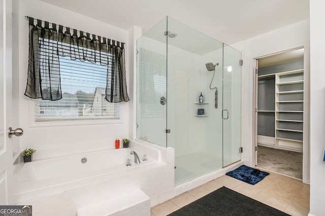 bathroom with tile patterned floors and separate shower and tub