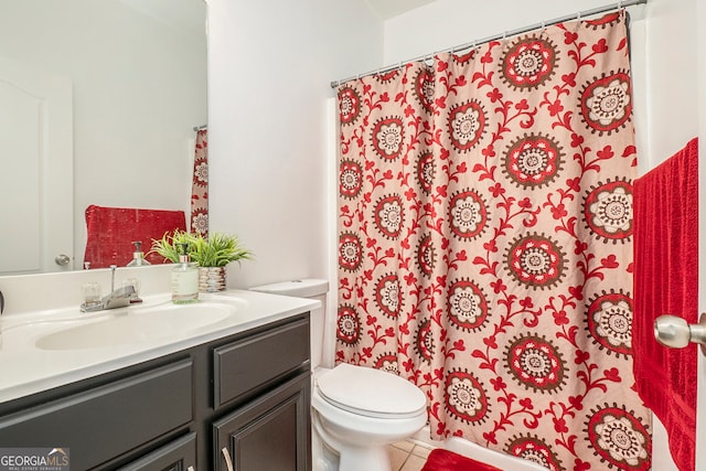 bathroom with tile patterned floors, vanity, and toilet