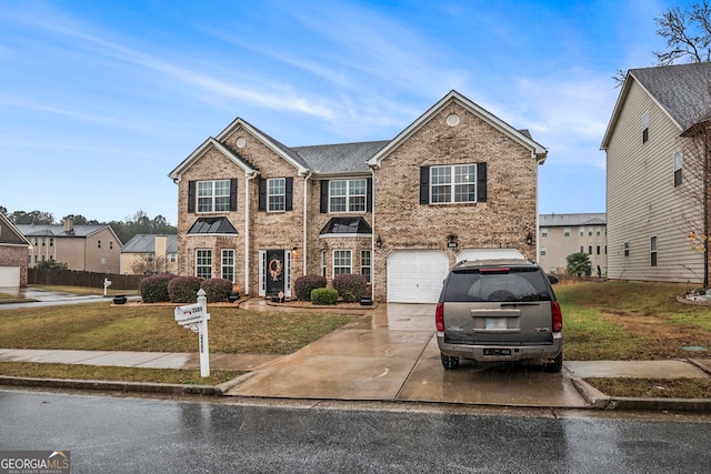 view of front of house featuring a garage and a front lawn