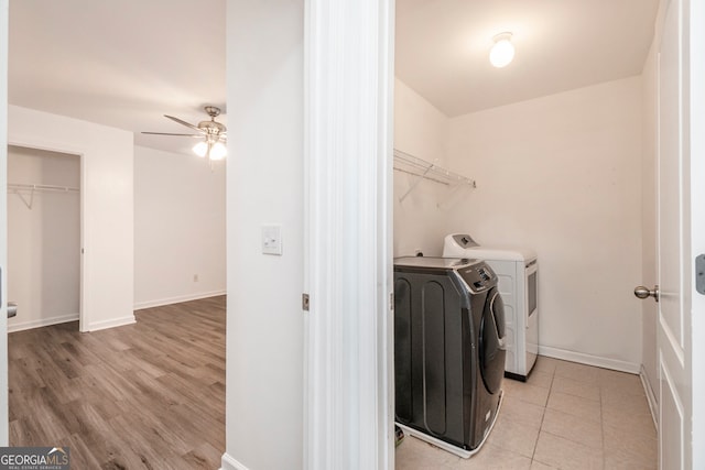 laundry room featuring light hardwood / wood-style flooring, ceiling fan, and washing machine and clothes dryer