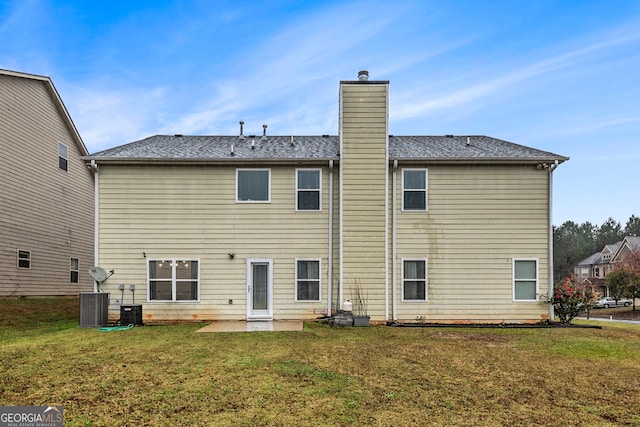 rear view of property with a yard and a patio