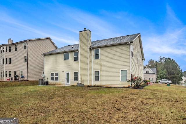 back of house featuring a lawn and a patio