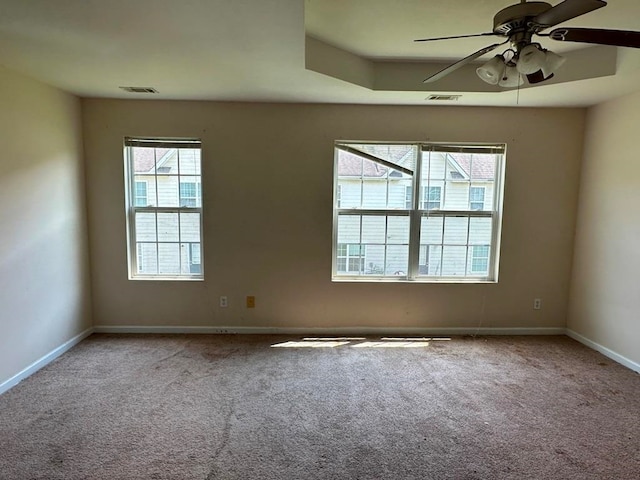 carpeted spare room with ceiling fan and a healthy amount of sunlight