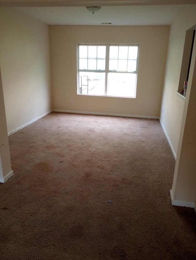 unfurnished room with light colored carpet