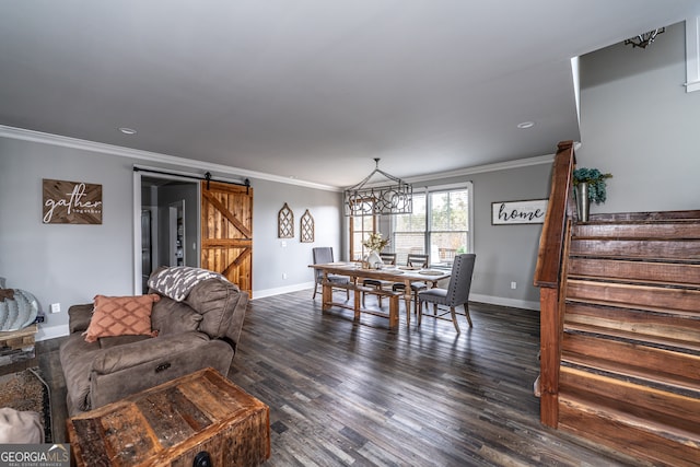 living room featuring a barn door, dark hardwood / wood-style flooring, and crown molding