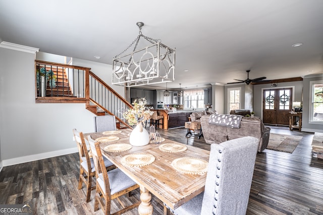 dining space featuring plenty of natural light, ceiling fan with notable chandelier, dark hardwood / wood-style floors, and ornamental molding