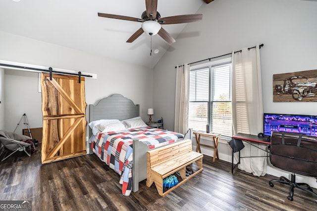 bedroom featuring a barn door, ceiling fan, dark wood-type flooring, and vaulted ceiling