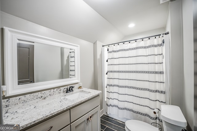 bathroom with vanity, curtained shower, and toilet