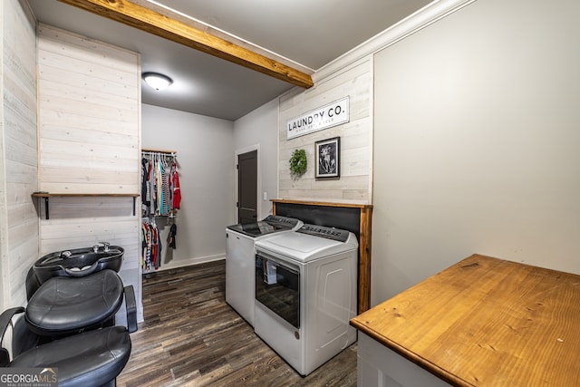 laundry area with dark hardwood / wood-style floors, wood walls, and washing machine and dryer