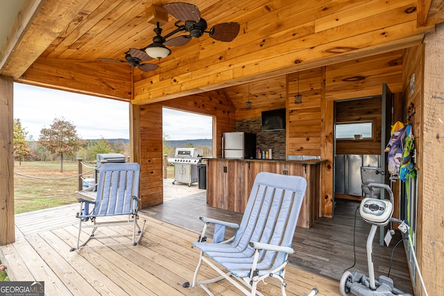 deck featuring a grill and ceiling fan