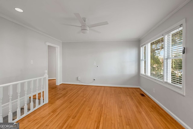 spare room with ceiling fan, light hardwood / wood-style floors, and ornamental molding