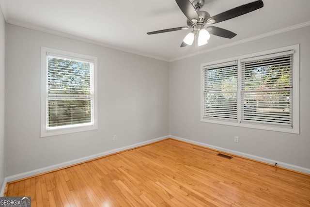 spare room featuring light hardwood / wood-style floors, ceiling fan, and ornamental molding