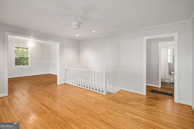 empty room featuring light wood-type flooring, ceiling fan, and ornamental molding