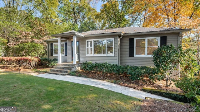 ranch-style home featuring a front yard