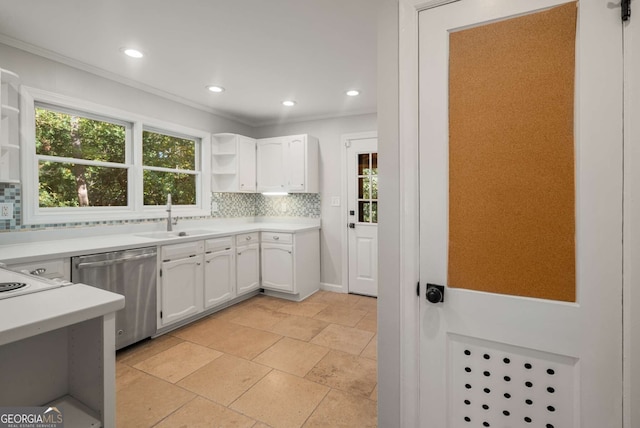 kitchen featuring tasteful backsplash, white cabinetry, sink, and stainless steel dishwasher