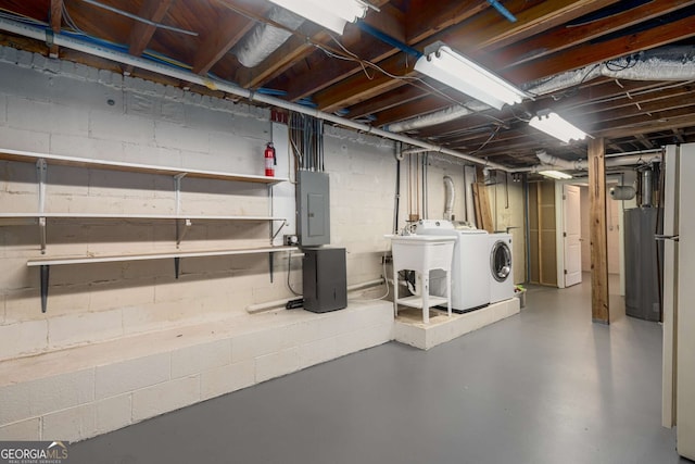 basement with electric panel, washer and clothes dryer, and sink