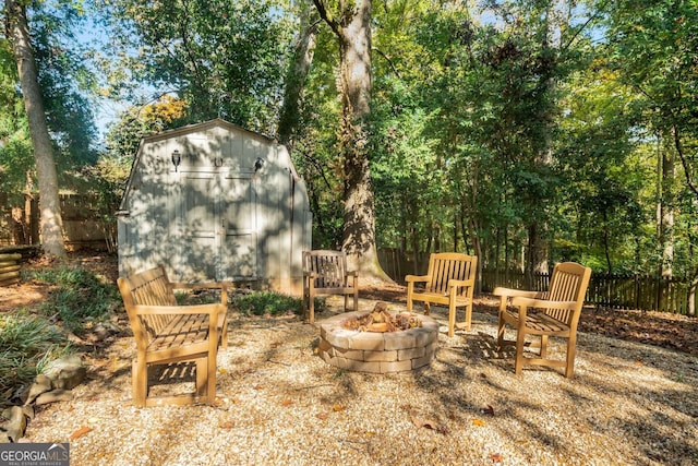 view of patio / terrace with a fire pit and a storage shed