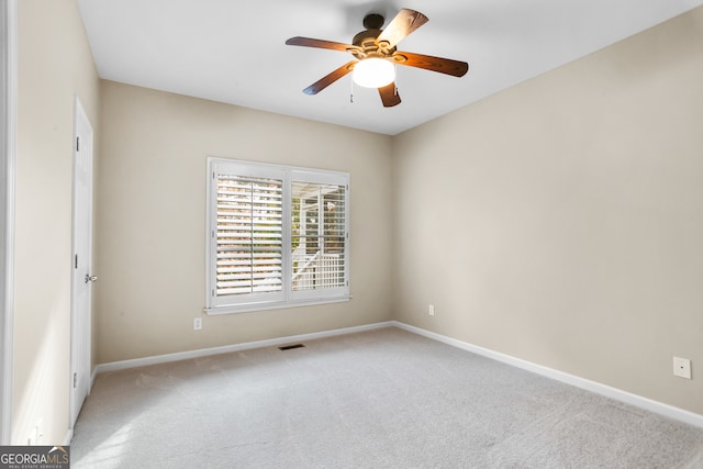 carpeted spare room with ceiling fan