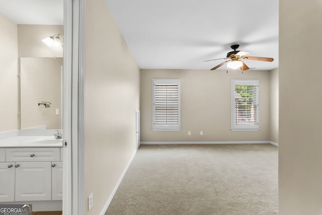 interior space with vanity and ceiling fan