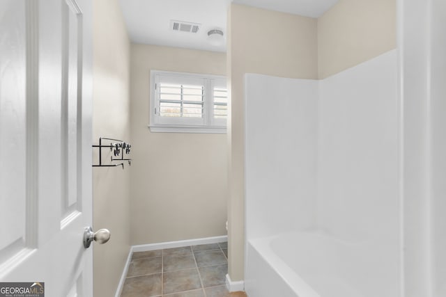 bathroom with tile patterned flooring and separate shower and tub