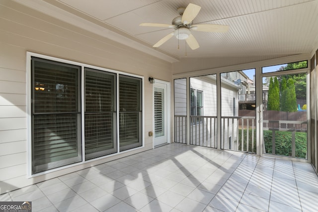 unfurnished sunroom featuring ceiling fan and lofted ceiling