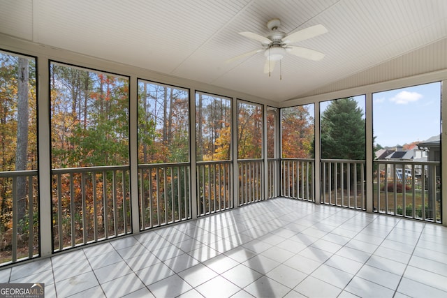 unfurnished sunroom with ceiling fan