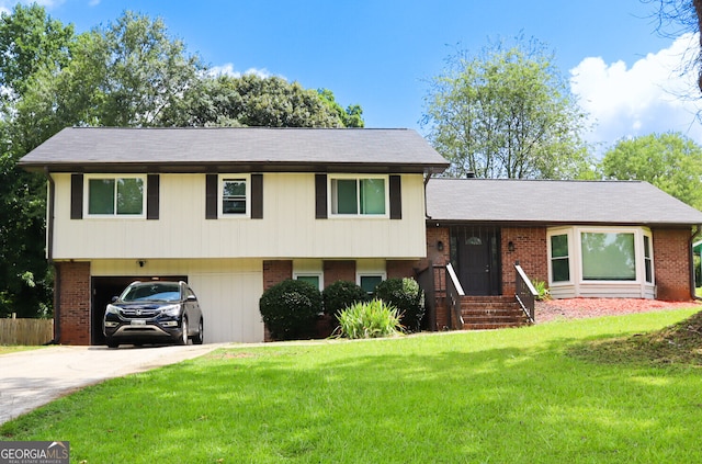 tri-level home featuring a front lawn and a carport