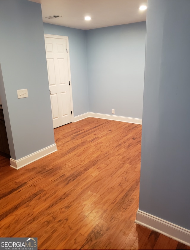 unfurnished room with light hardwood / wood-style floors