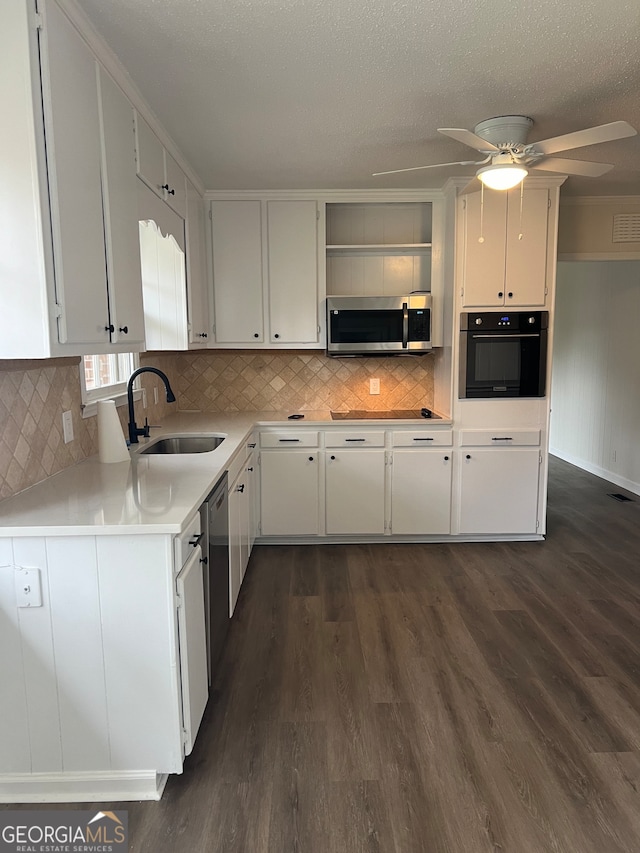 kitchen featuring black appliances, dark hardwood / wood-style floors, white cabinetry, and sink