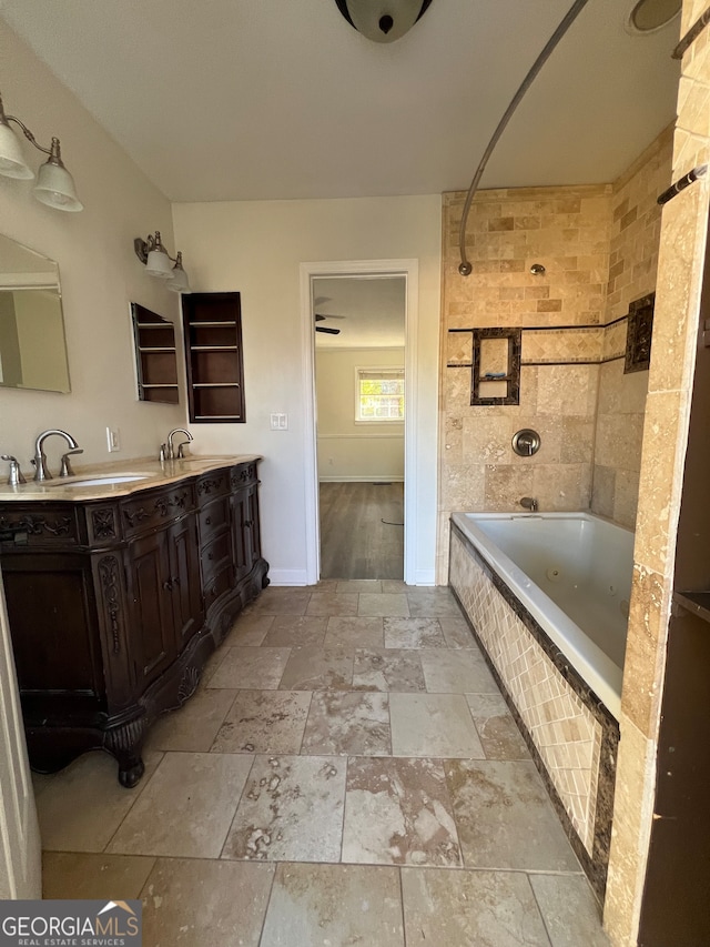 bathroom with vanity and tiled shower / bath