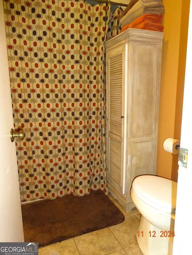 bathroom with walk in shower, tile patterned flooring, and toilet