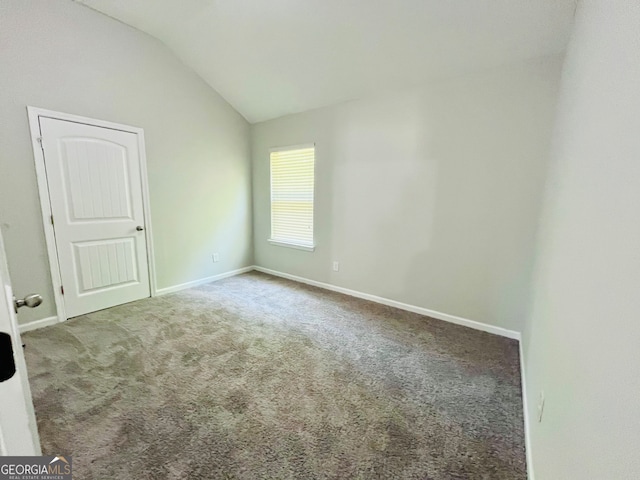 unfurnished room with carpet and lofted ceiling