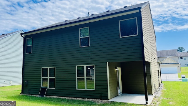 rear view of property featuring a lawn and a patio area