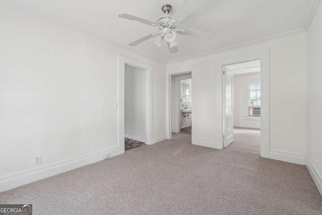 unfurnished room with ceiling fan, light colored carpet, and ornamental molding