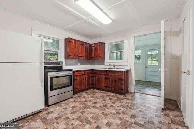 kitchen featuring sink, white refrigerator, plenty of natural light, and electric stove