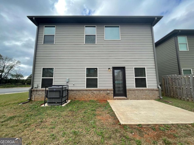 back of house with a patio area, central AC unit, and a lawn