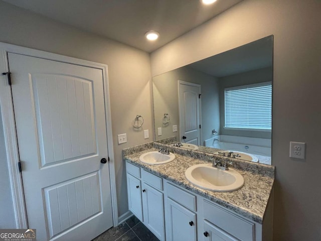 bathroom featuring vanity, tile patterned flooring, and a bathing tub