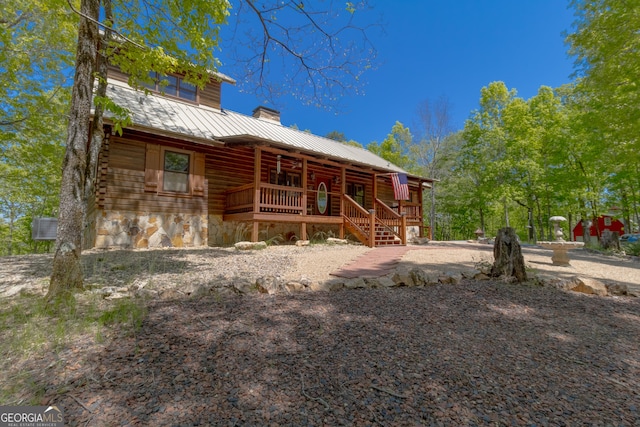 739 Barnes Mill Rd, Hamilton, GA 31811 - rear view of house with a porch, stone siding, metal roof, a chimney, and a standing seam roof