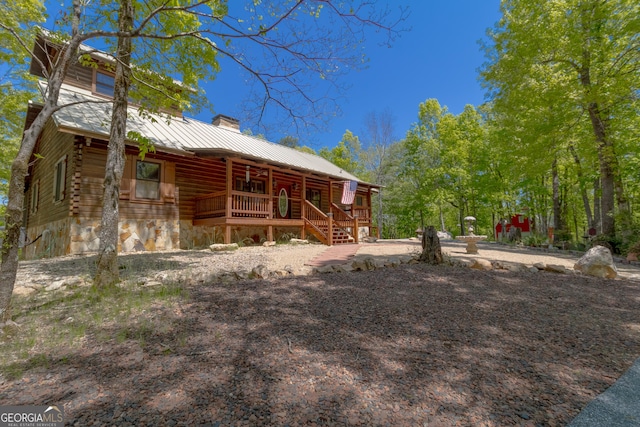 739 Barnes Mill Rd, Hamilton, GA 31811 - back of property with a porch, a chimney, log siding, and metal roof