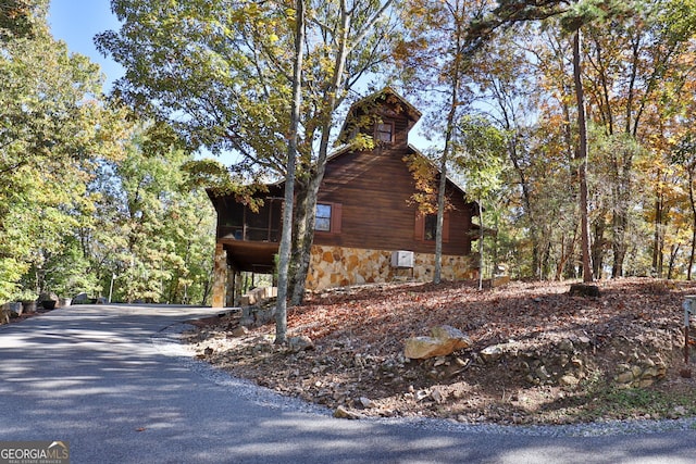 view of property exterior featuring a sunroom