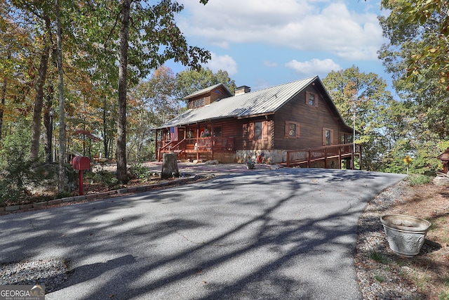 739 Barnes Mill Rd, Hamilton, GA 31811 - view of home's exterior with a chimney, metal roof, and a deck