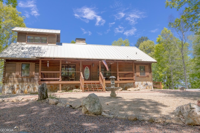 739 Barnes Mill Rd, Hamilton, GA 31811 - log cabin with a porch, a ceiling fan, metal roof, a chimney, and a standing seam roof