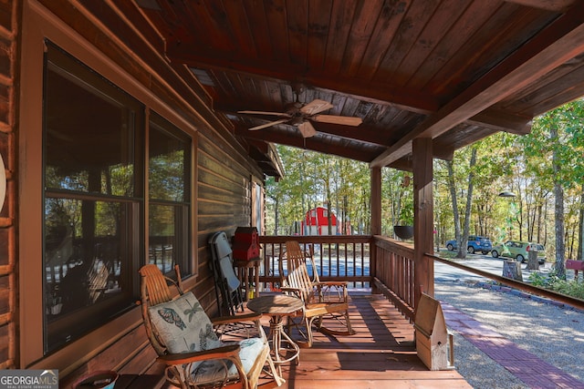 wooden terrace with ceiling fan and covered porch