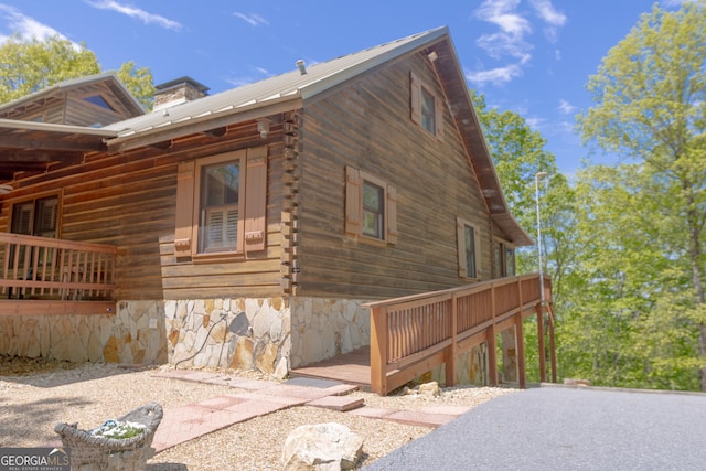 739 Barnes Mill Rd, Hamilton, GA 31811 - view of side of home with log exterior, metal roof, and a chimney
