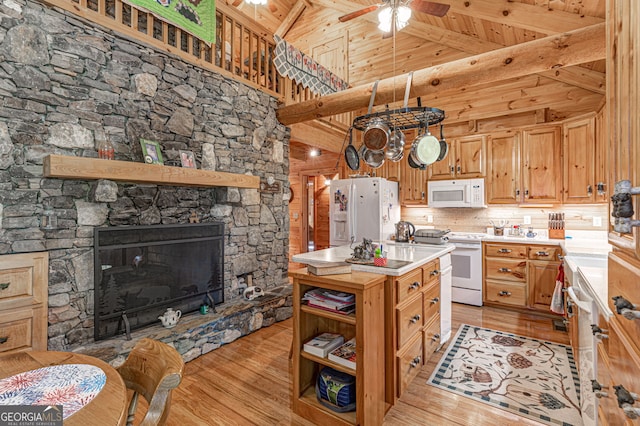 kitchen featuring ceiling fan, beamed ceiling, white appliances, wood ceiling, and light wood-type flooring