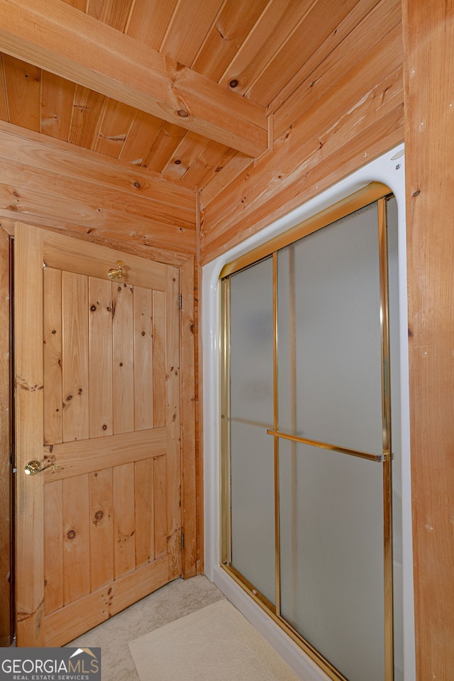 bathroom with walk in shower, wooden ceiling, and wood walls