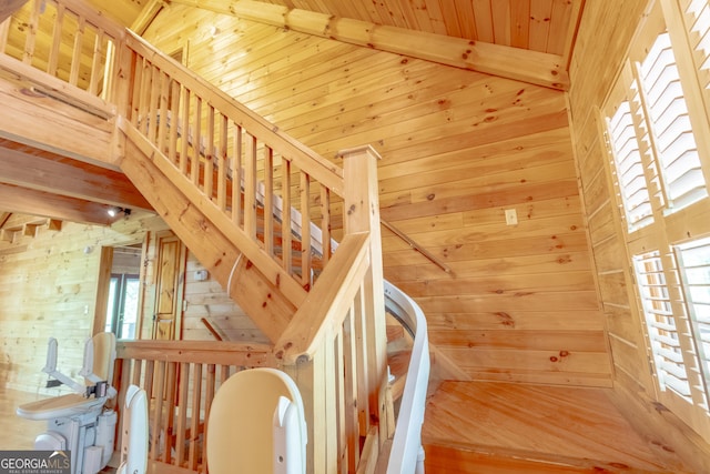 739 Barnes Mill Rd, Hamilton, GA 31811 - stairs with a healthy amount of sunlight, wooden walls, and lofted ceiling with beams