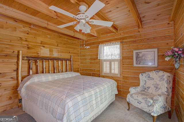 carpeted bedroom featuring beamed ceiling, ceiling fan, wooden walls, and wood ceiling