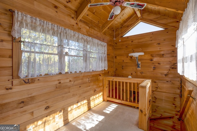 unfurnished bedroom featuring multiple windows, wooden walls, and wood ceiling