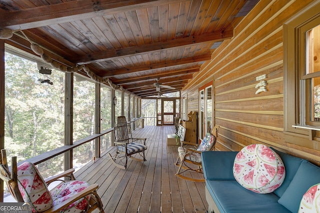 unfurnished sunroom featuring vaulted ceiling with beams and wood ceiling